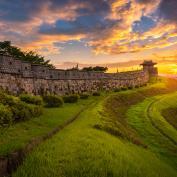 Fortress walls on hill at Suwon at sunset