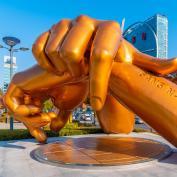 Sculpture of golden hands resting on each other as a Gangnam Style monument in Seoul