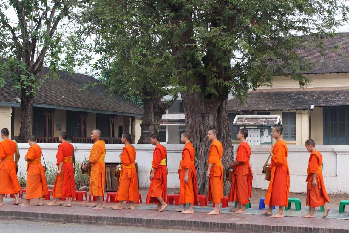 Monks file past during the morning alms