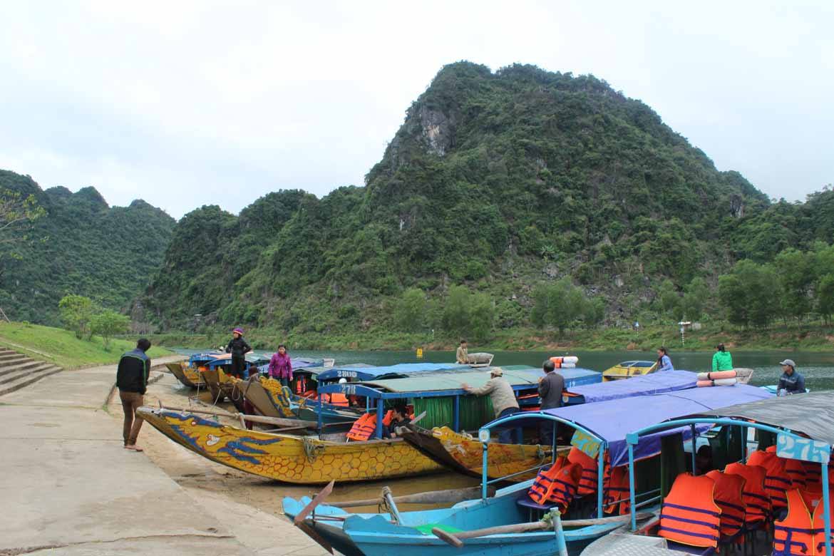 Longtail boats wait to take passengers to Phong Nha Cave