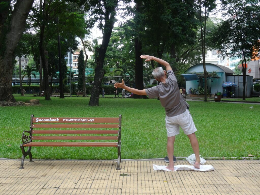 Man does Tai Chi in Tao Dan Park, Vietnam