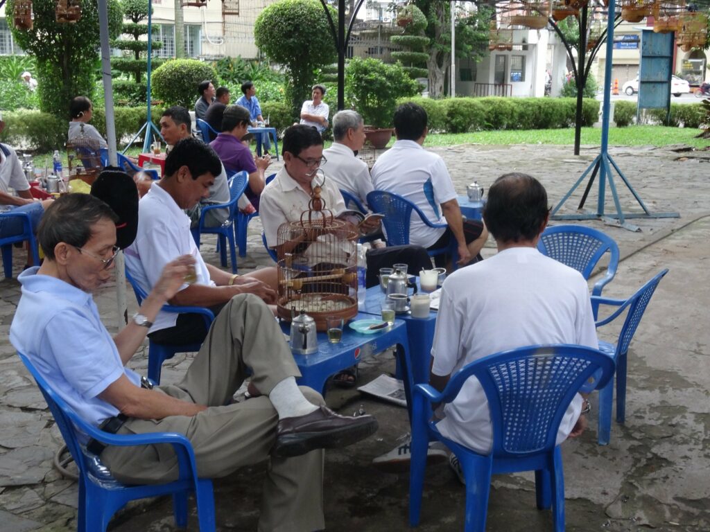Vietnamese men relaxing and drinking coffee in Tao Dan Park