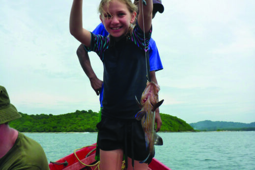 Girl on a fishing boat in Burma - Family holiday in Burma