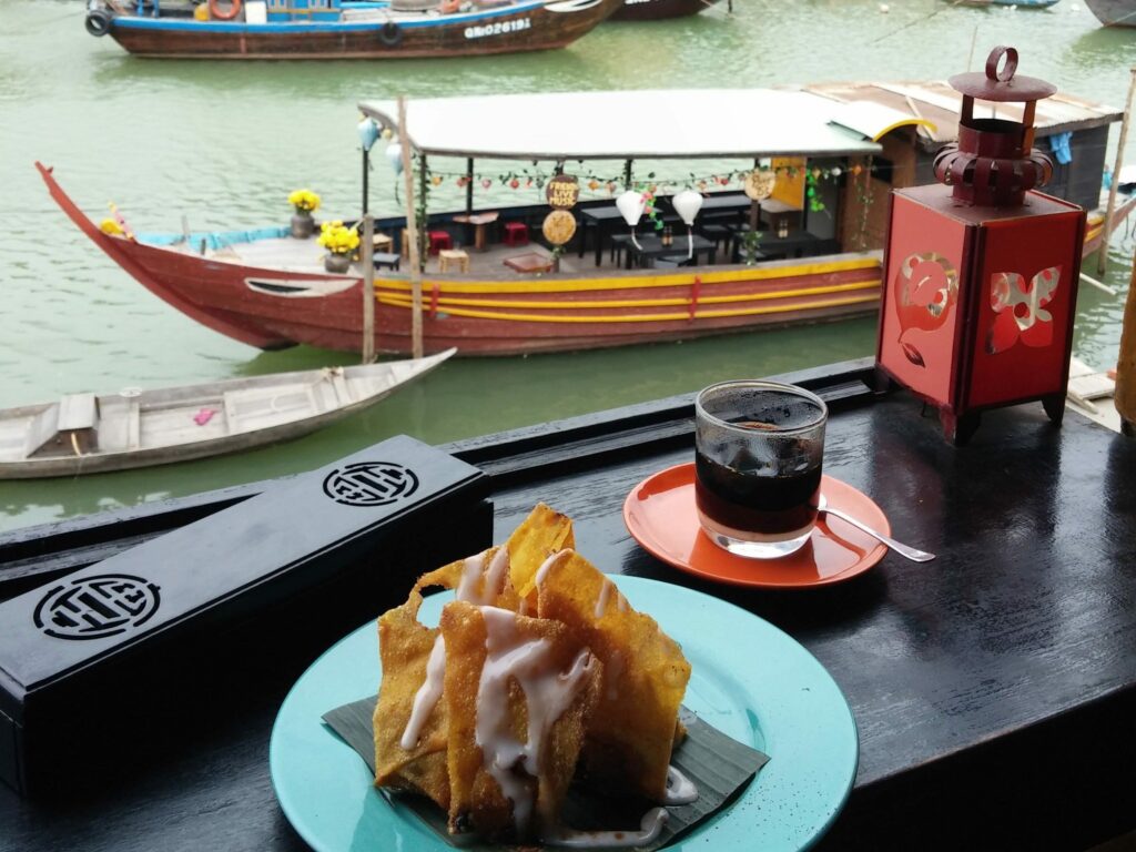 Drinking black coffee and looking out to the harbourside in Vietnam