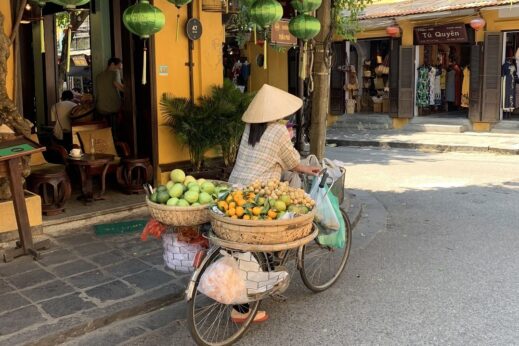 Hoi An, Vietnam - lady pushing bicycle