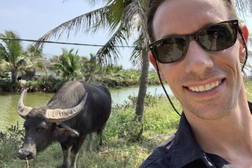 Tyler making friends with a buffalo in Hoi An, Vietnam