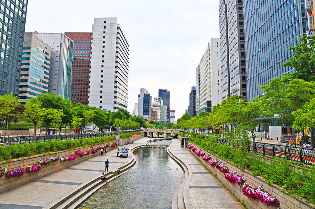 People walk along Cheonggycheon stream in Seoul