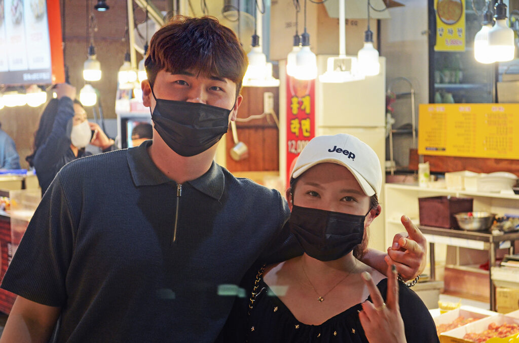 Korean couple wearing masks in a market in Seoul