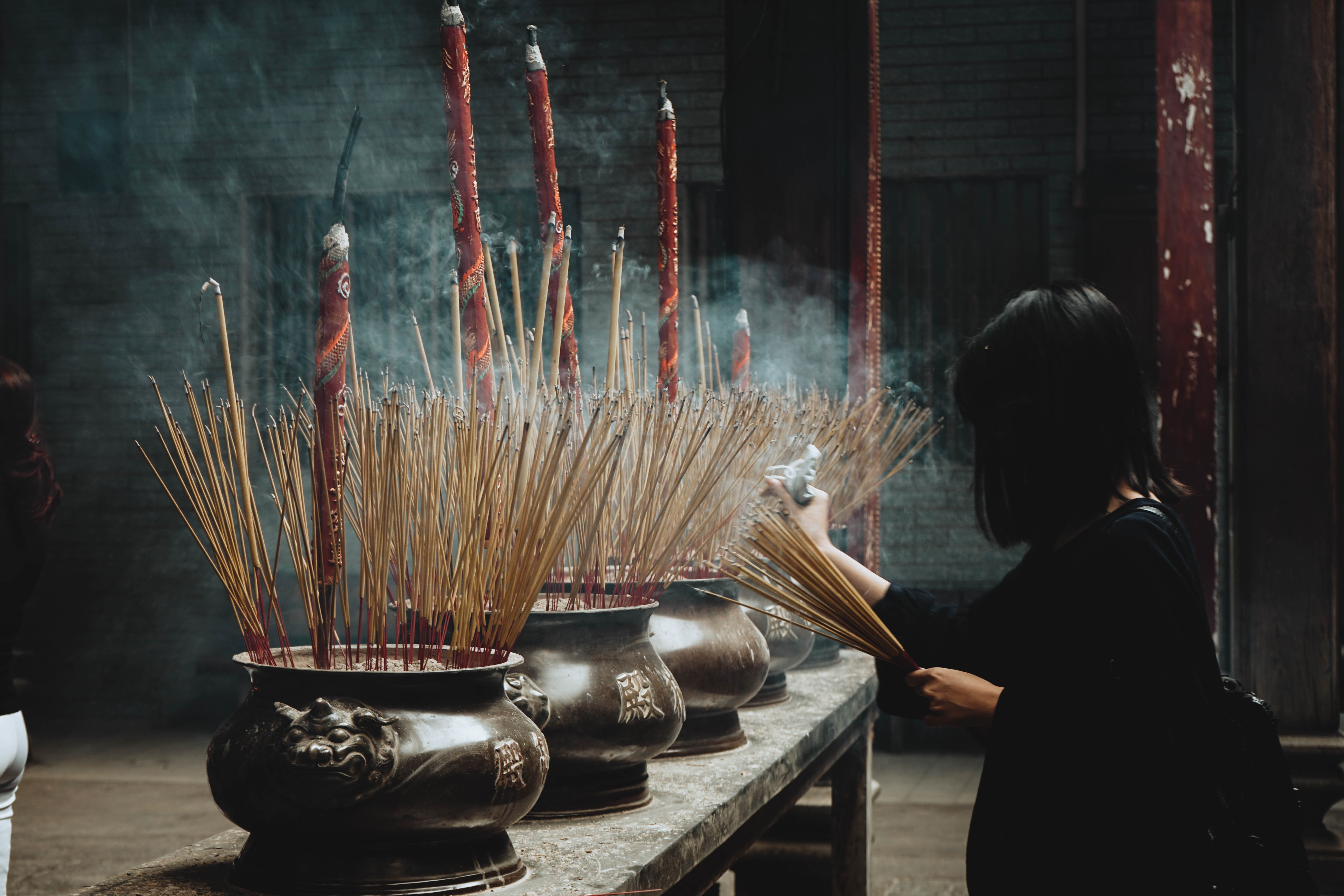 Vietnam_HoChiMinchCity_Thien Hau Temple__chinh-le-duc-iXeddfYn5cs-unsplash.jpg A woman lights incense at a shrine