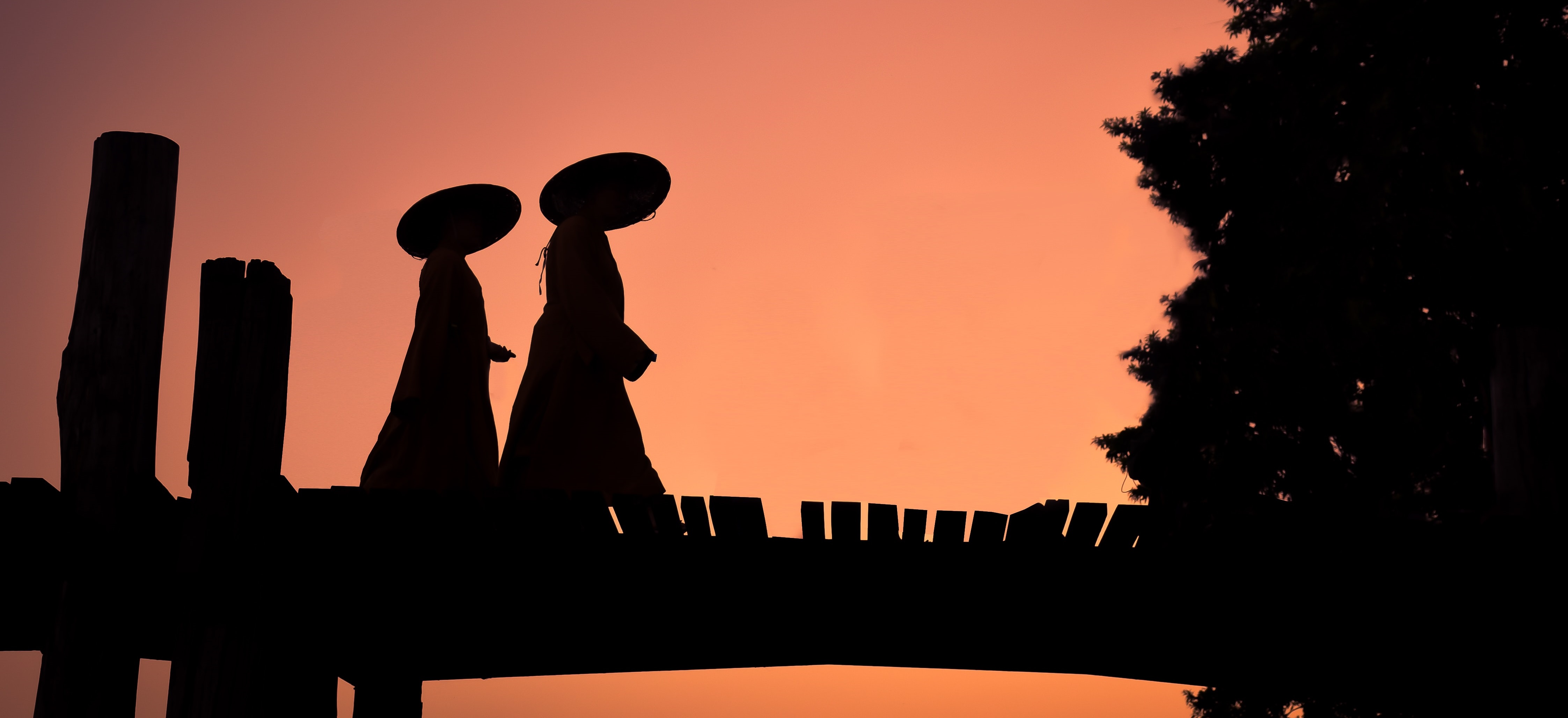LONG READ HERO Myanmar sergio-capuzzimati-ihry1T_uMpI-unsplash.jpg Figures in local garb at dusk