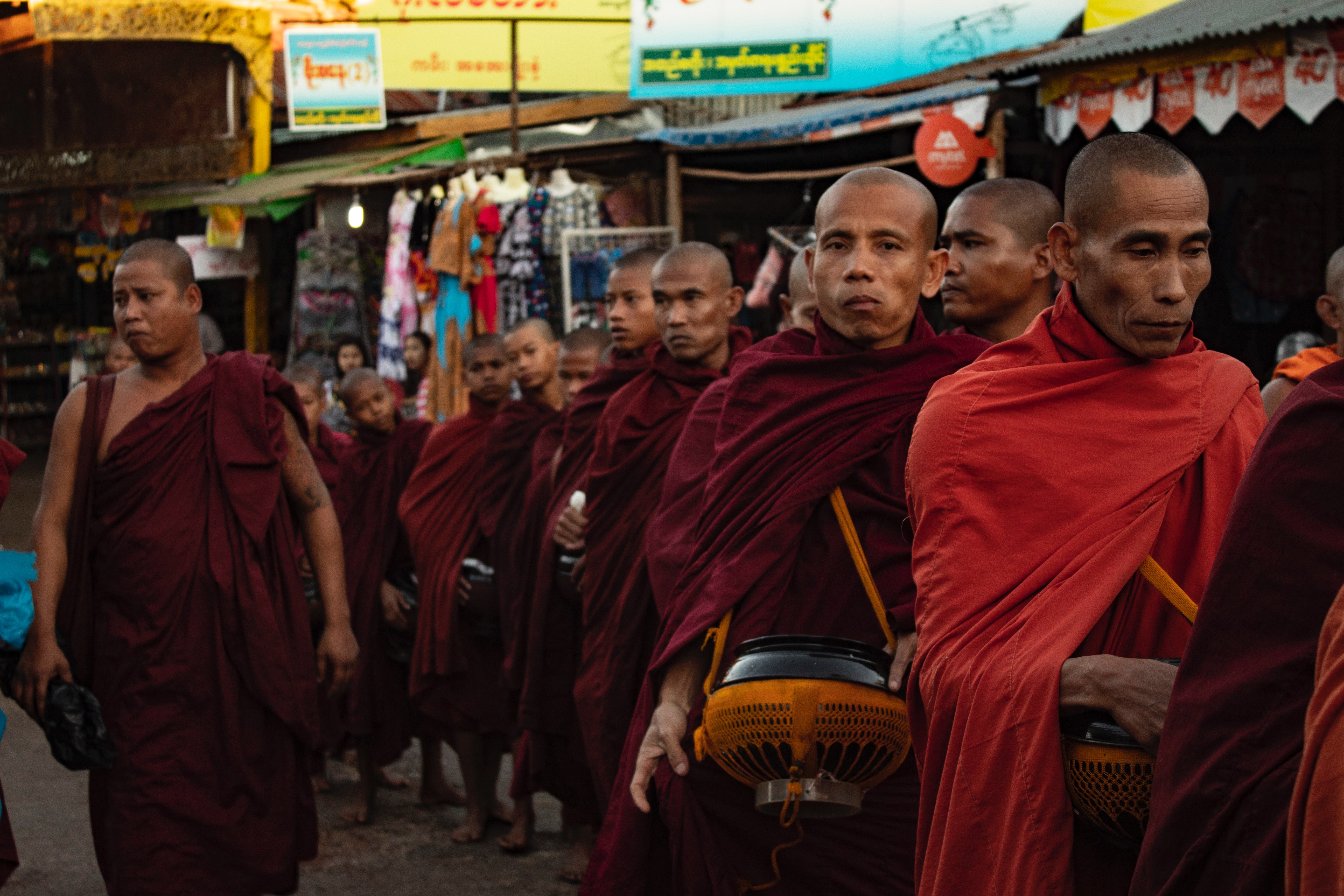 Monks walking through a market in Myanmar