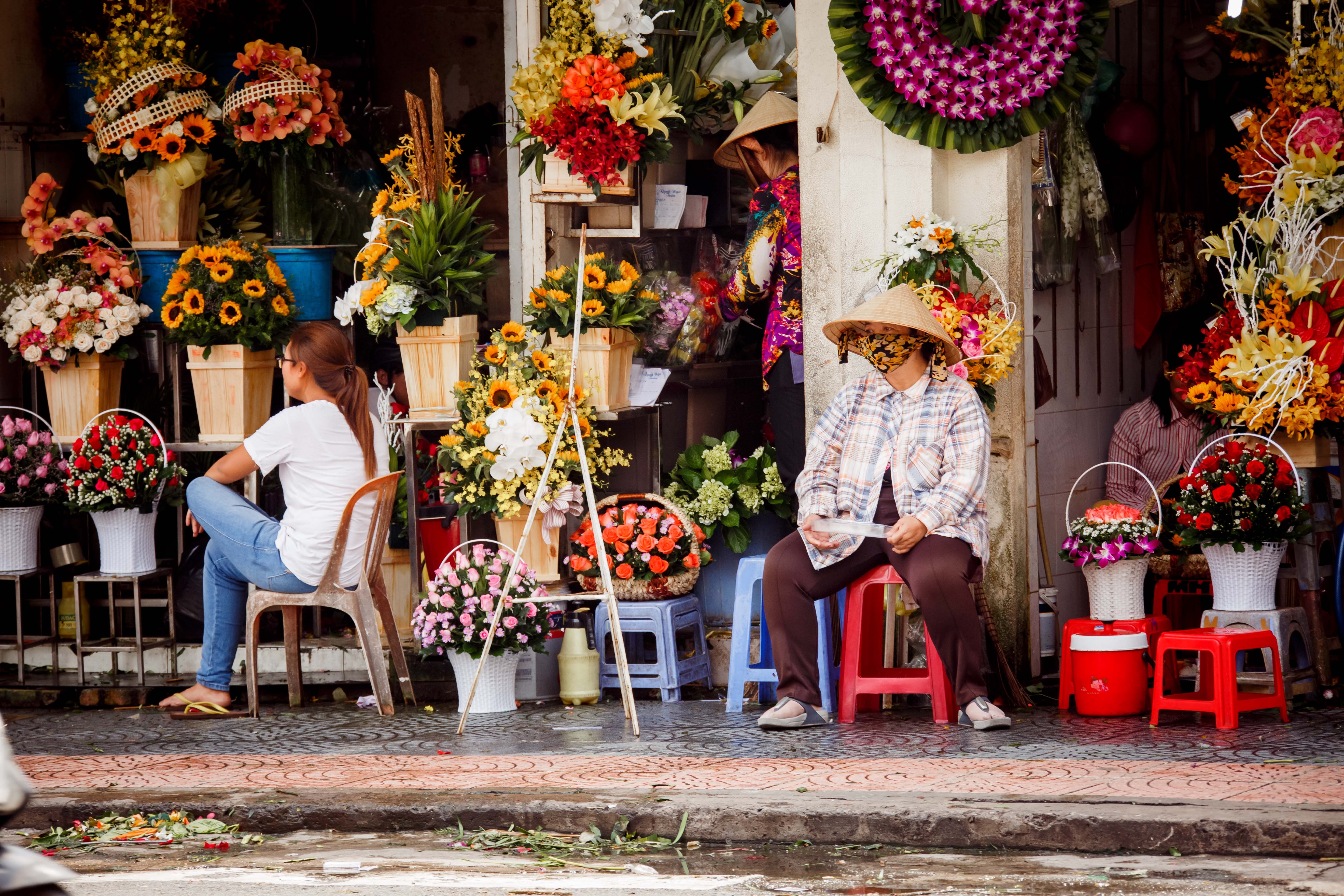 Vietnam Covid Hero-unsplash.jpg Vietnam woman at market wearing a face mask