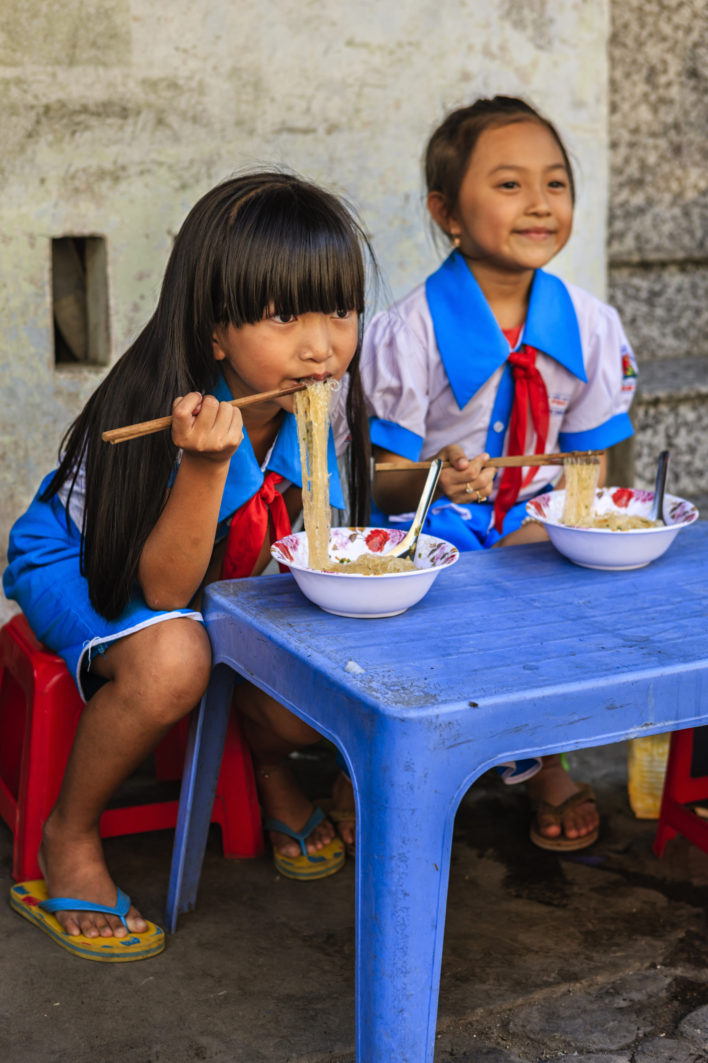 Vietnamese schoolgirls eating a pho bo_iStock-1146441101_hadynyah.jpg Vietnamese schoolgirls eating pho in Hanoi