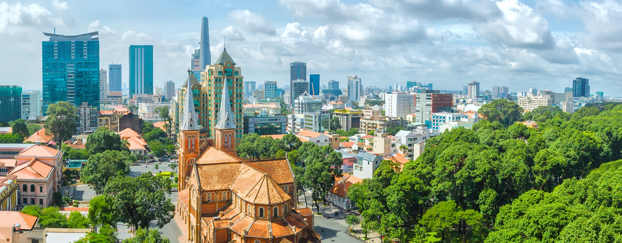 Ho_Chi_Minh_City_Cathedral_Hero_C Aerial view of Ho Chi Minh City cathedral, with motorcyclists riding on the streets around it