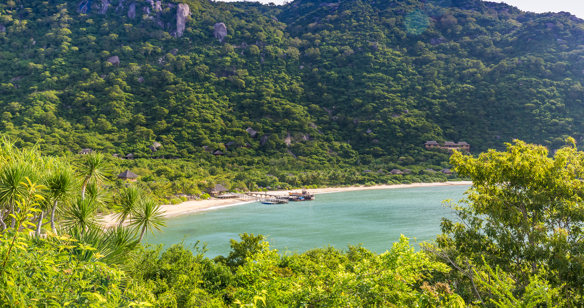 Ninh_Van_Bay_Simon_Dannhauer_Hero.jpg Aerial view of Ninh Van Bay, with a pier jutting out in the middle of the beach surrounded by lush mountains