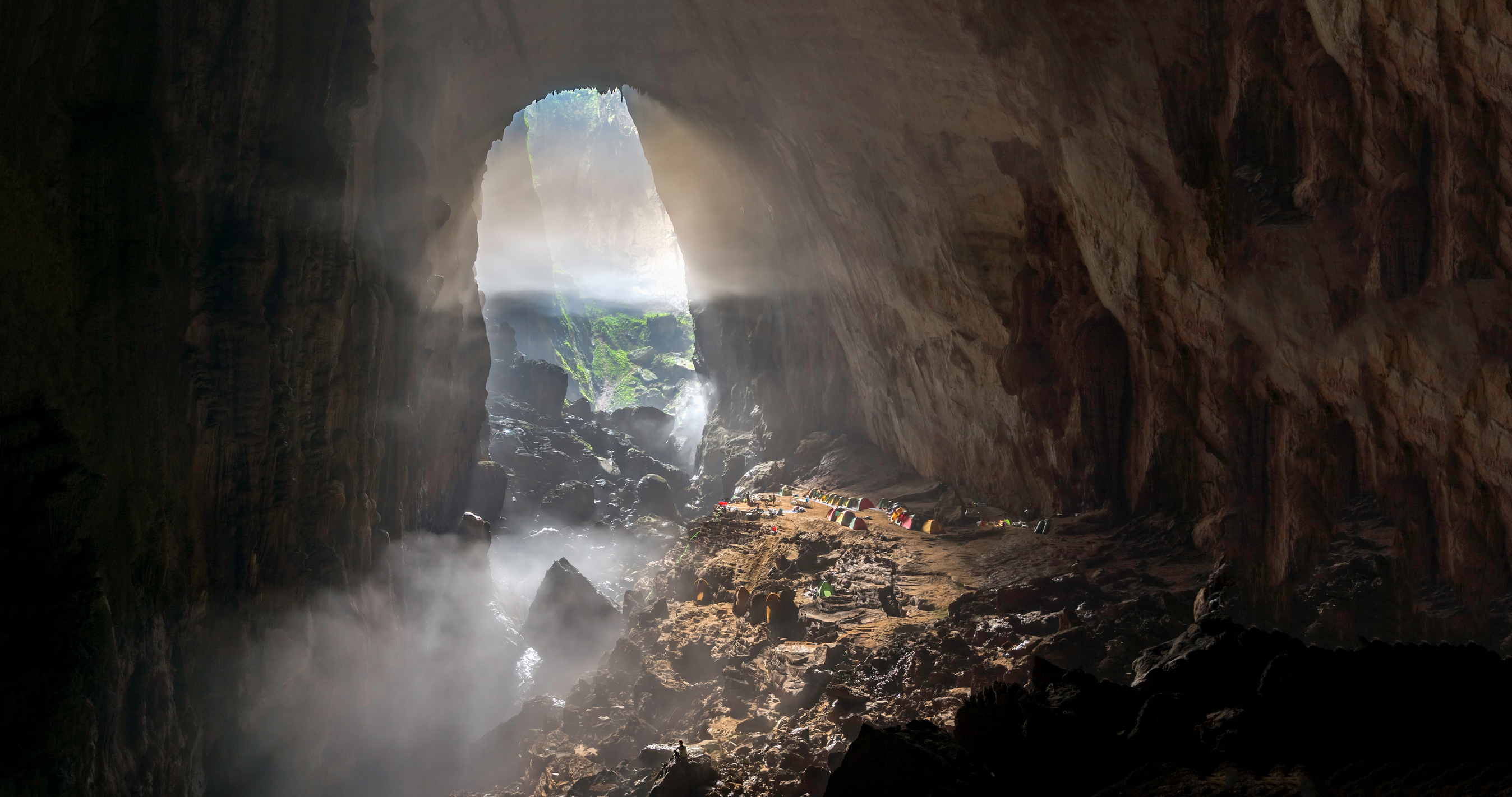 Phong-Nha-Son-Doong-Cave-geng-xu-Hero-B.jpg Mist gently covers individual tents lined up in massive cave entrance in Son Doong, Phong Nha