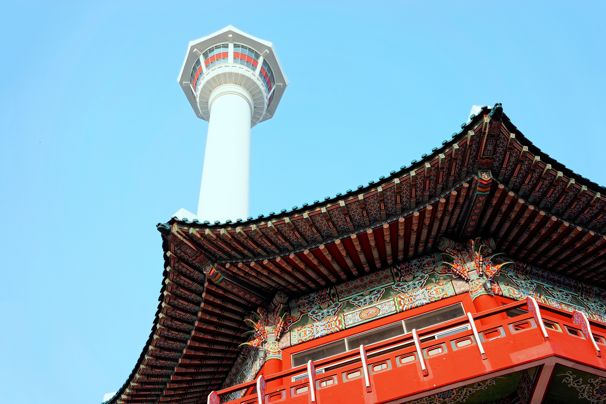 Busan tower and temple at Yongdusan Park.jpg Red temple roof and Busan Tower in background