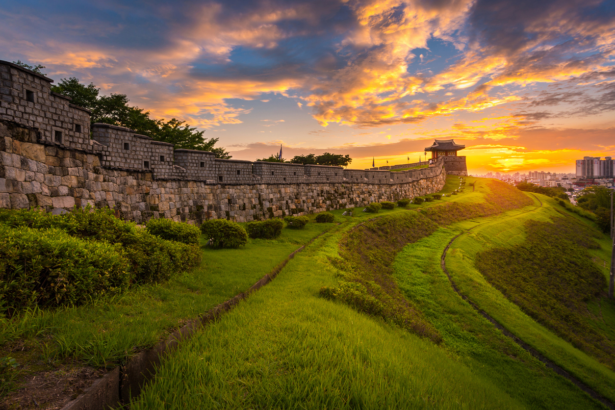 Fortress walls on hill at Suwon at sunset