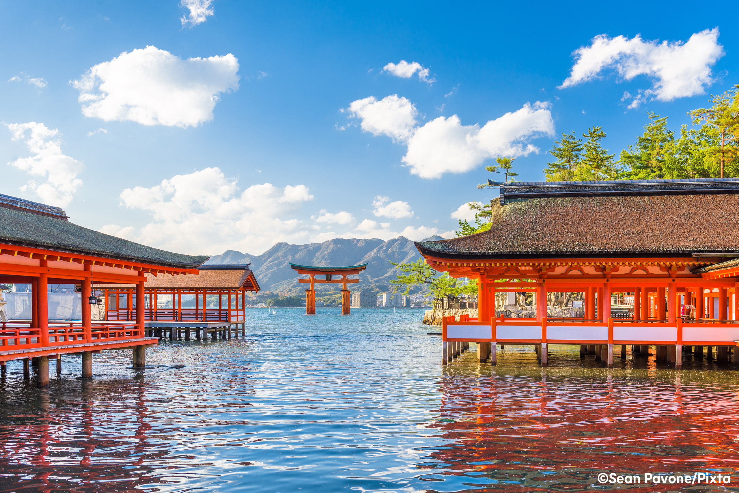 Place Hero Miyajima - Sean Pavone - Pixta - needs crediting.jpg View across water towards Miyajima's red floating torii gate