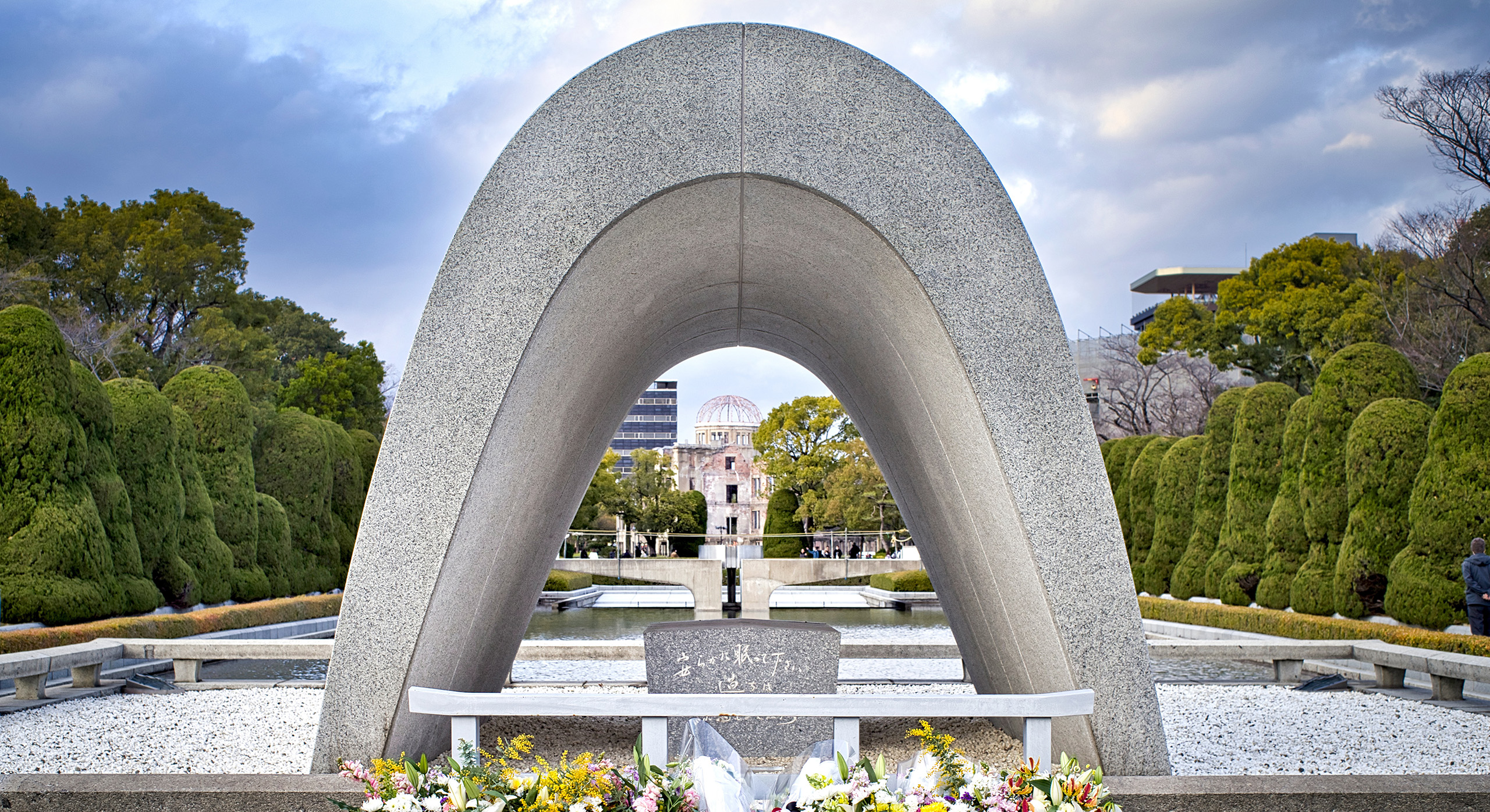 Place-hero-hiroshima-memorial-park2 Stone arch with flowers in front at the peace memorial in Hiroshima