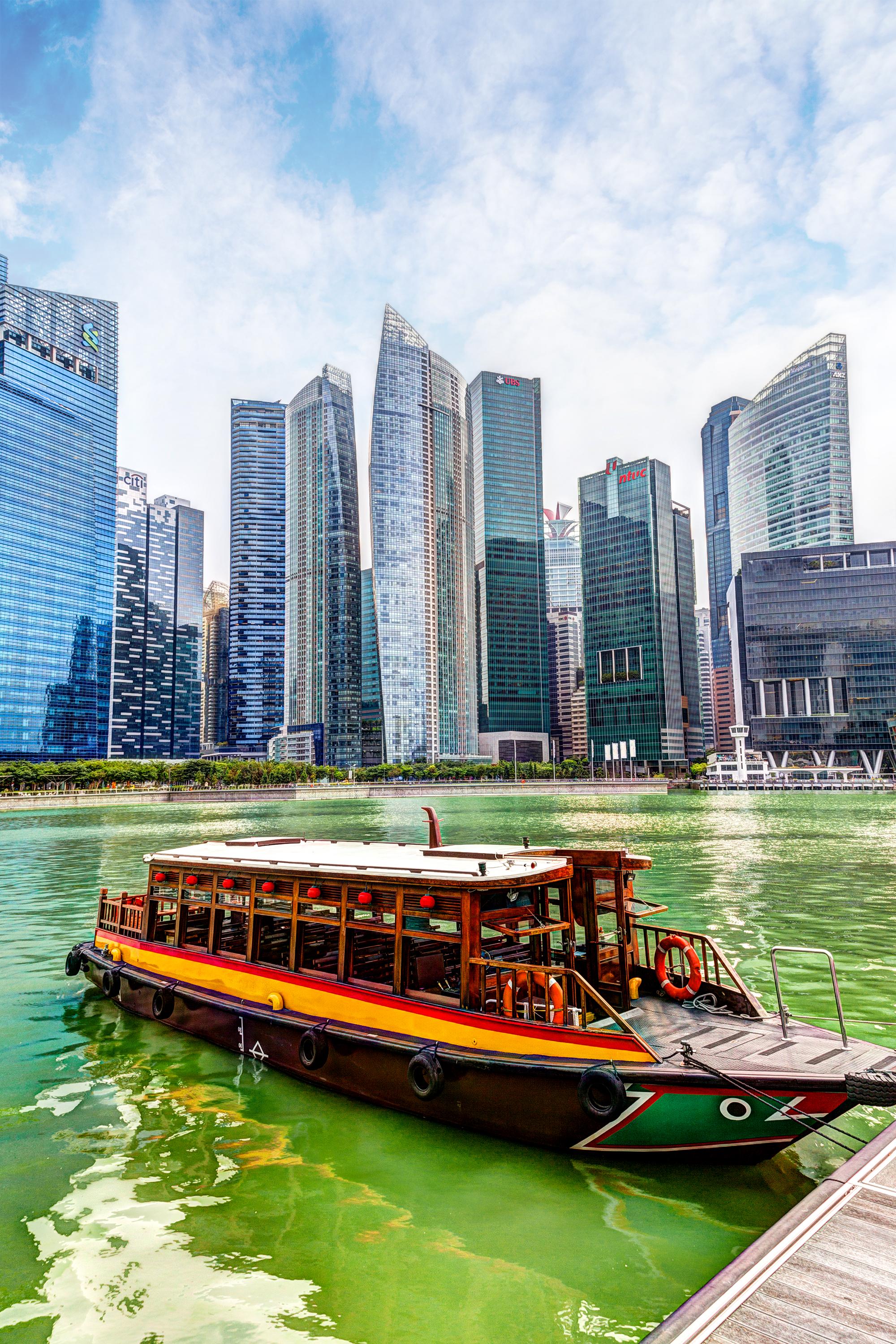 Singapore Business District on the Marina Bay_iStock-476173618_ronniechua1.jpg Bum boat at Marina Bay in Singapore's Business District