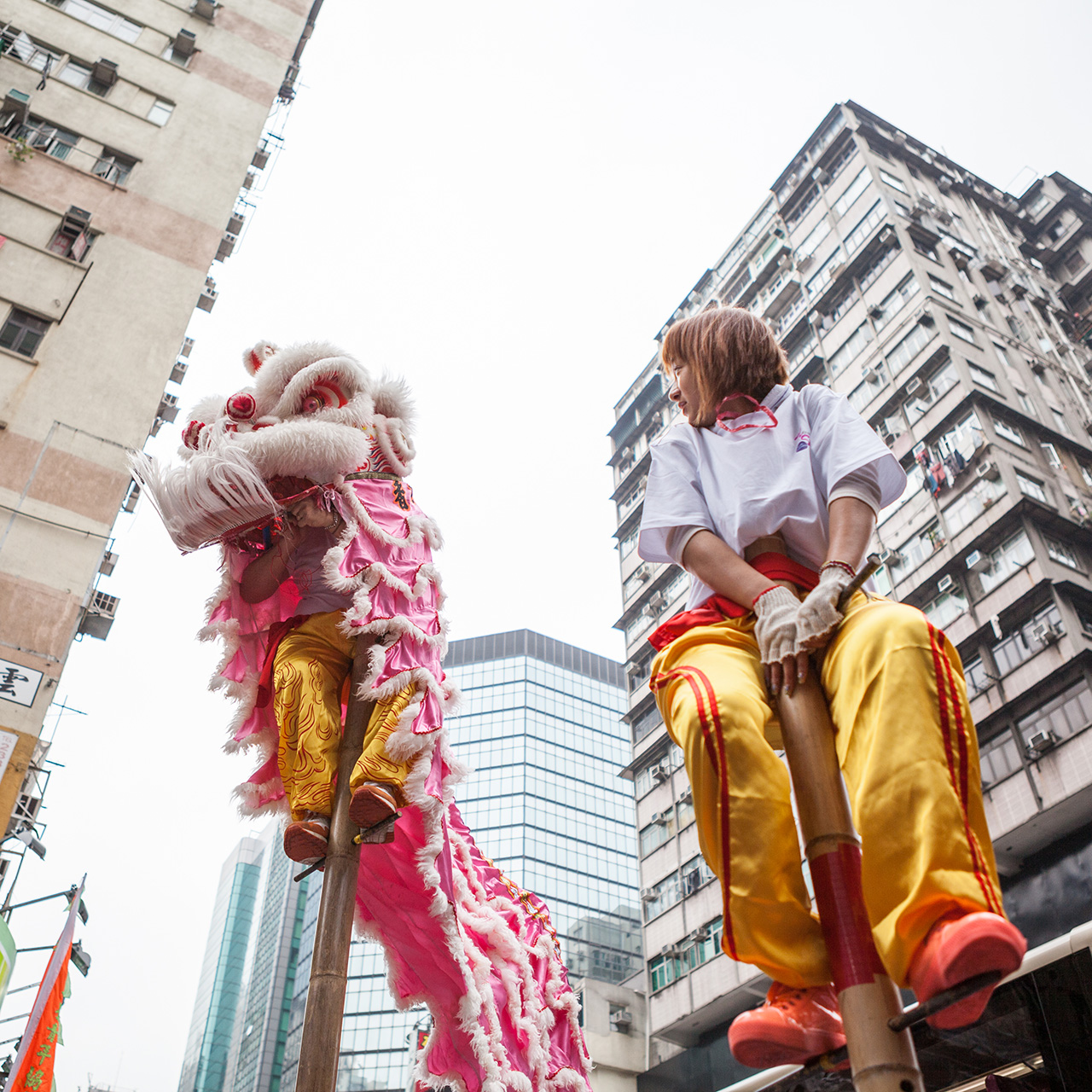 Chinese New Years - performers in Mong Kok.jpg Ladies perched on top of stilts in dragon costume for Chinese New Year celebrations