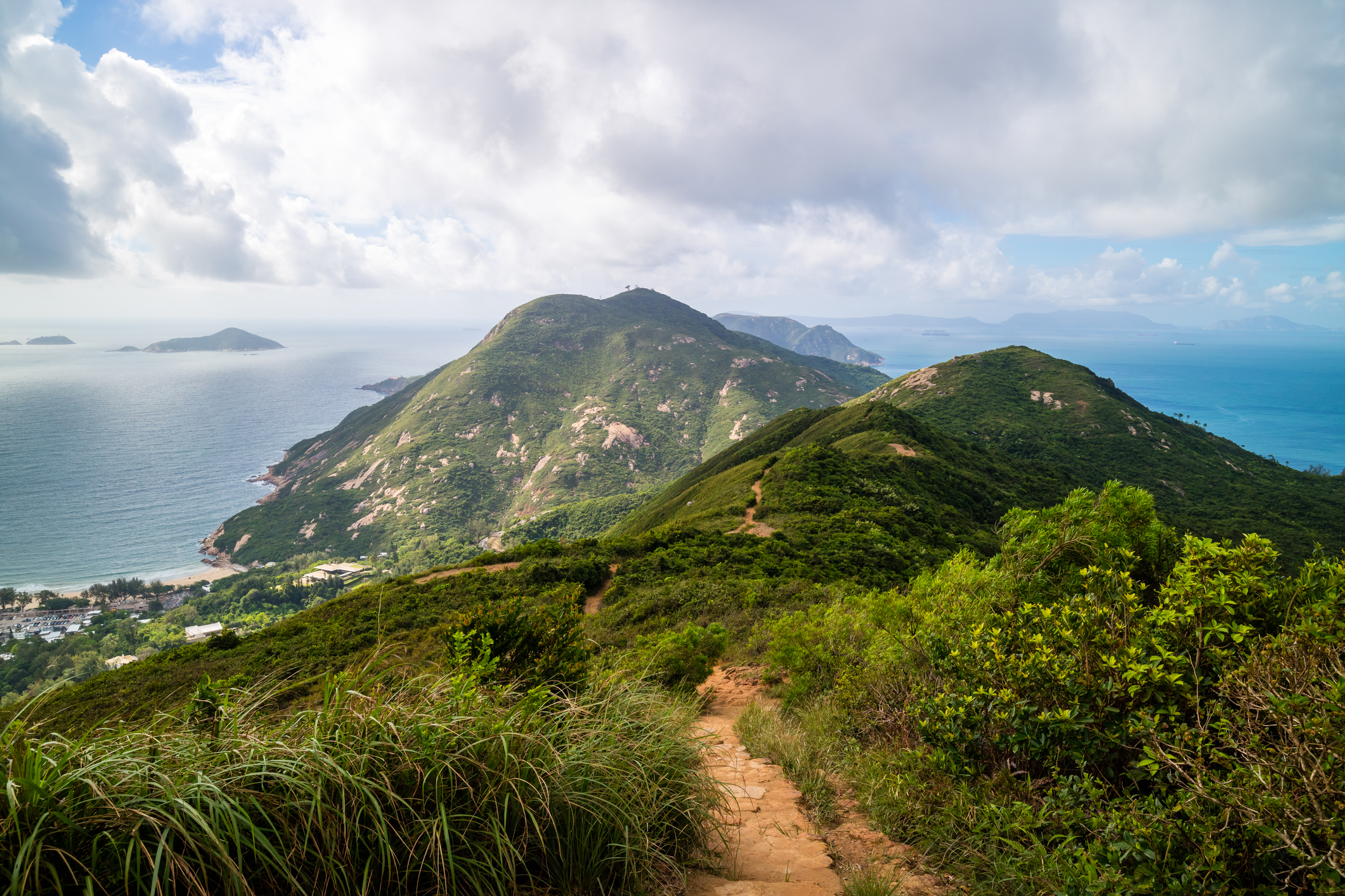 Dragon 's Back mountain trail_iStock-865741458_pawinp.jpg View from the top of the Dragon's Back Trail looking down at the sea