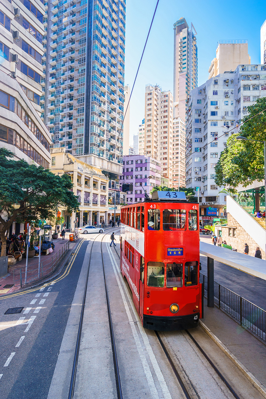 iStock-1153441900_CHUNYIP WONG.jpg Red tram surrounded by skyscrapers