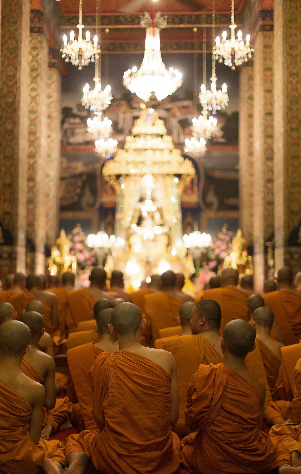 Monks Bangkok.jpg Monks kneeling and praying inside illuminated temple in Bangkok