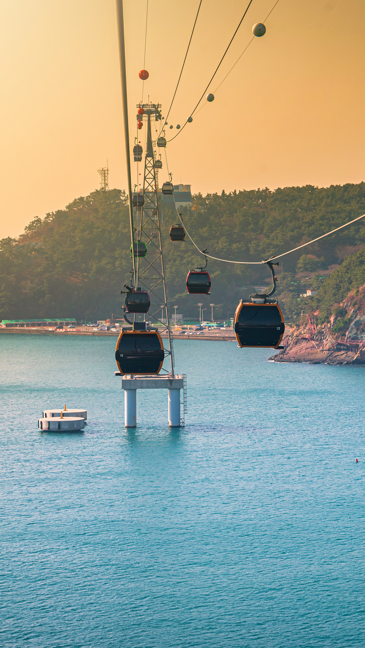 Gallery - SKFA Haundae Cable Car Haeundae Cable Cars gently advance over the ocean during a warm sunset in Busan South Korea