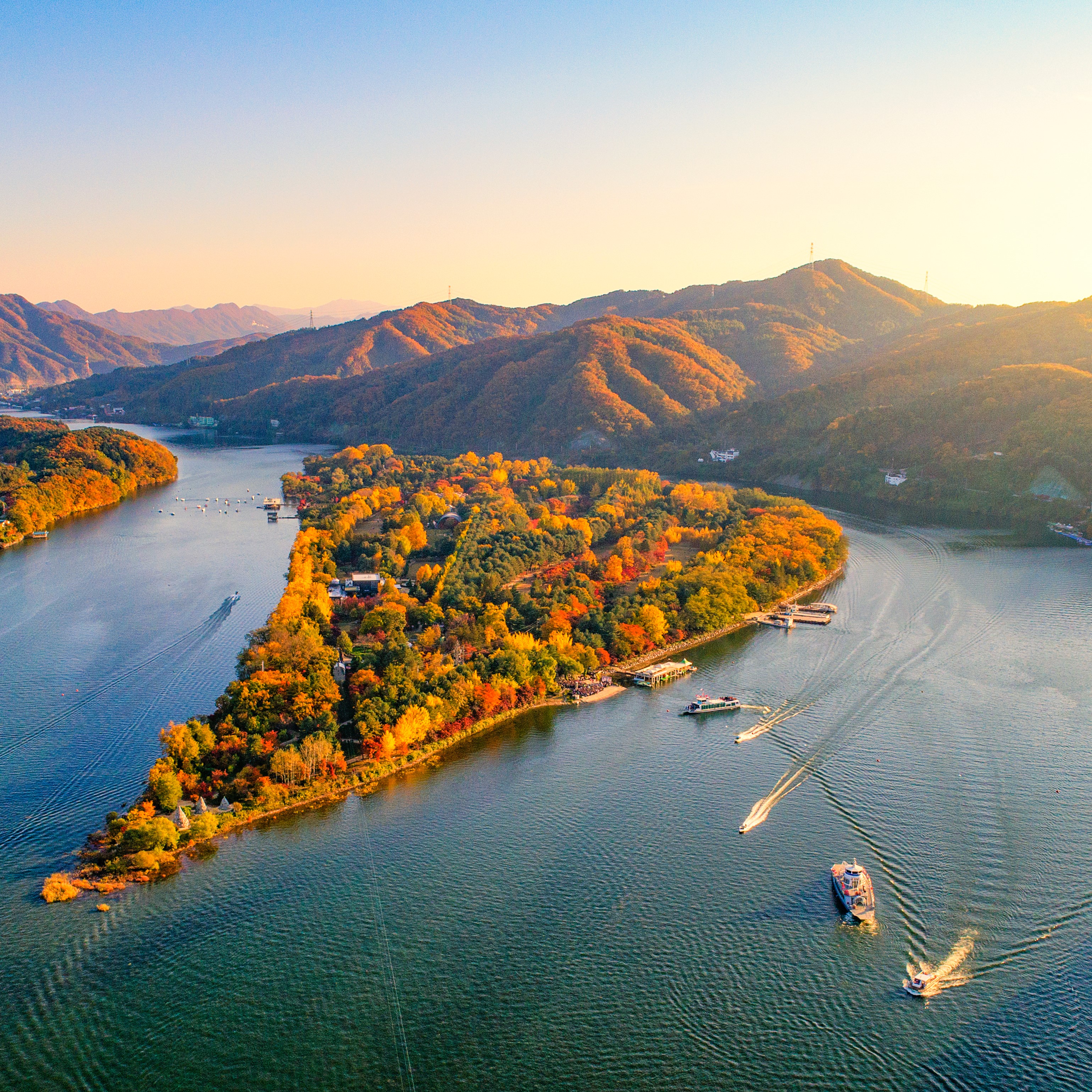 SKFA Seoul 1-4 S Nami Island 1 Shutterstock Nami Island near Seoul is lit up by warm sunset colours, with boats navigating the waters around the island