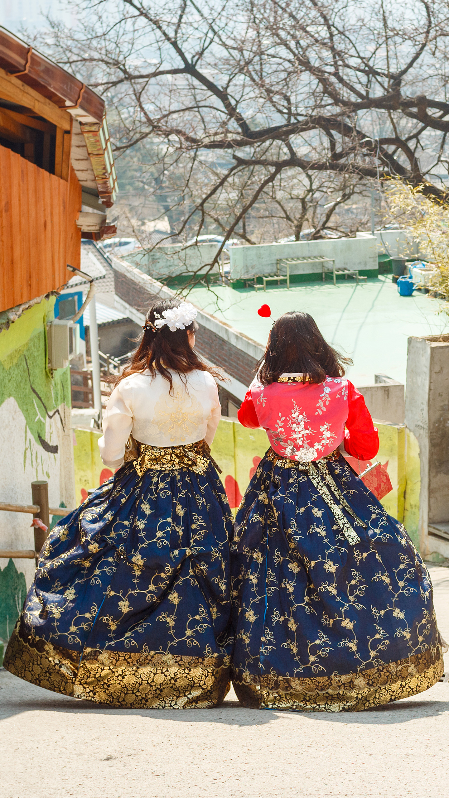 Gallery KW Jeonju Section Women in Hanbok Two women walk side by side in traditional hanbok dresses in Jeonju, South Korea