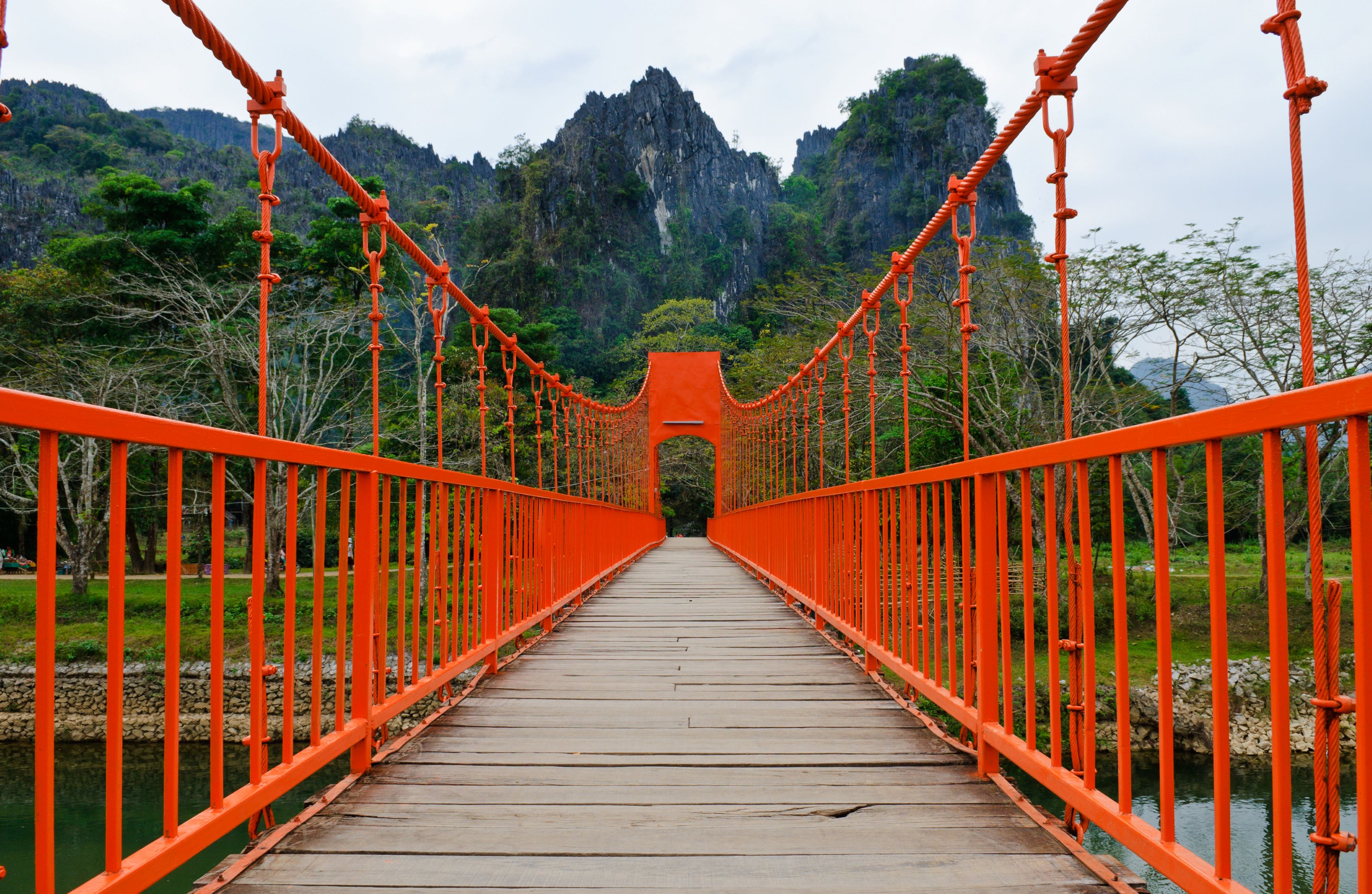 Vang Vieng Laos Red Bridge Red foot bridge with dramatic mountain scenery in background