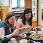Two competition winners in South Korea eating traditional food