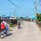 Two people cycling along a quiet street in Udo Island