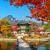 Pagoda on island in lake surrounded by autumn leaves