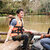 Sam Kemp sitting by a river with a life jacket on