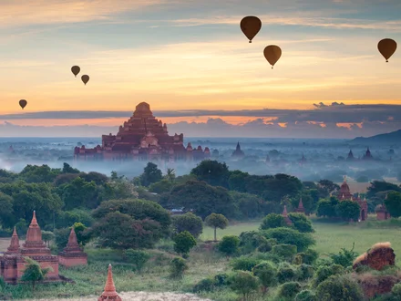 Hot air balloons flying over the plains of Bagan