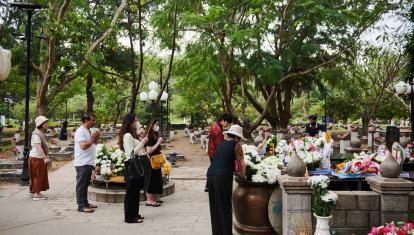 Vietnamese people after a pilgrimage to Con Son’s Hang Duong cemetery to lay chrysanthemums, lotus flowers and paper tributes at the grave of Vo Thi Sau 