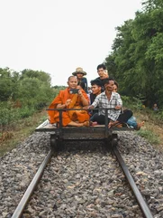 Cambodia Battambang Monk Bamboo Train with a monk taking a photo on his phone