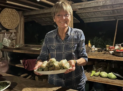 Tourist making summer rolls with local Laos family
