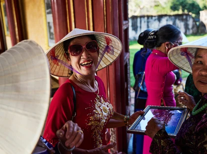 Vietnamese lady laughing in a traditional hat