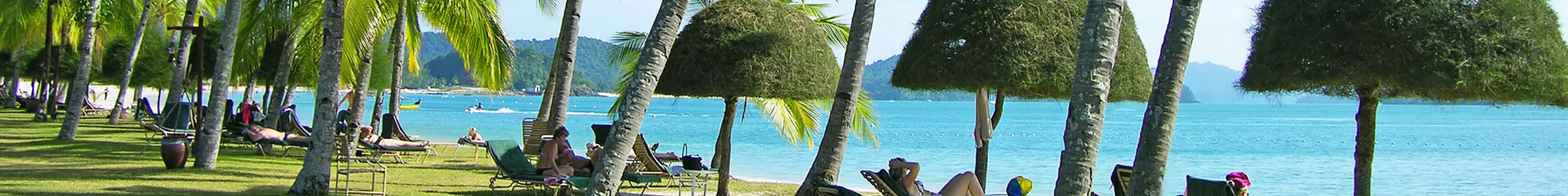 Travellers enjoy a beautiful sunny day at Cenang beach in Langkawi, Malaysia