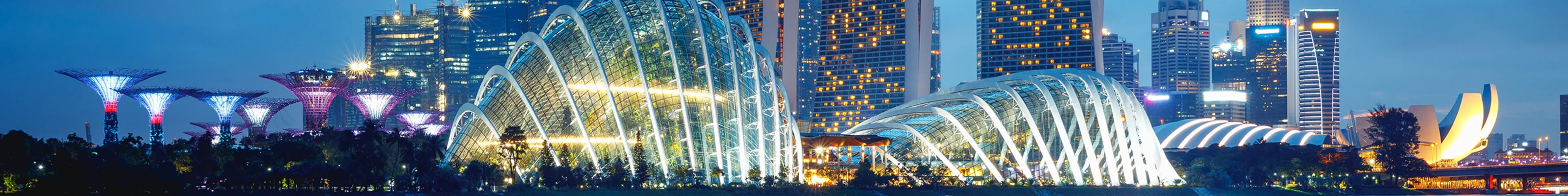 Dusk view of a different angle of Marina Bay in Singapore, with Marina Bay Sands and the Supertree Grove in view