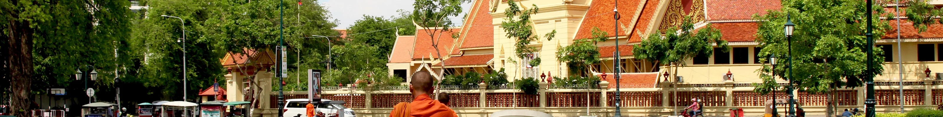 Monk walking towards the City Court House, although looks like a temple. Its next to the Royal Palace in Phnom Penh..