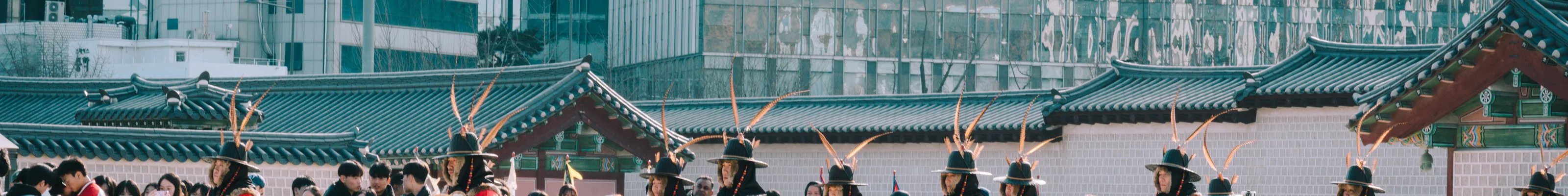 Changing of the guard ceremony in Seoul Palace in front of modern skyscraper buildings