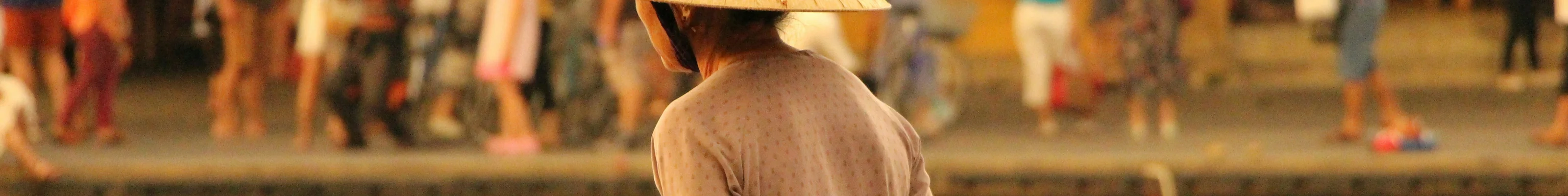Local Vietnamese woman looking over the lantern lit river in Hoi An 