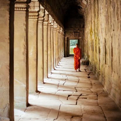 Monk walking under temple arches