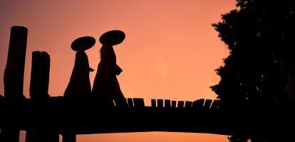 Figures in local garb at dusk