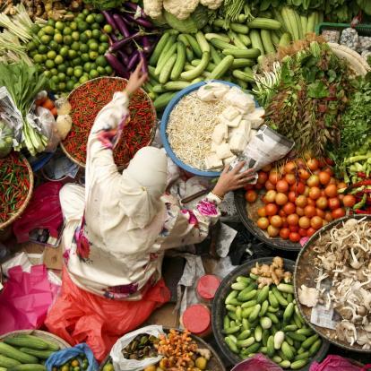 muslim woman selling fresh vegetables at market in kota baru malaysia